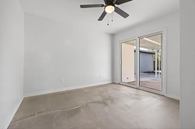 a view of a house with backyard and a patio