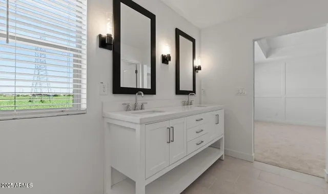 a bathroom with a double vanity sink and a mirror