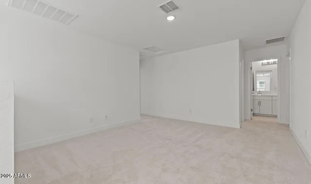 an empty room with windows and closet