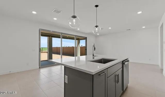 a kitchen with a sink and living room