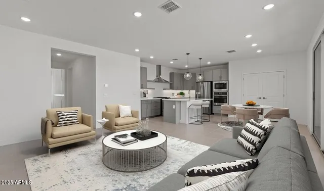 a living room with furniture and kitchen view