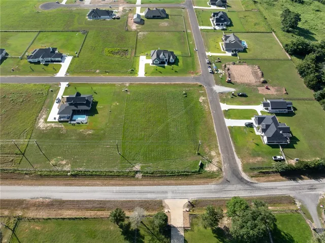 an aerial view of a residential houses with outdoor space