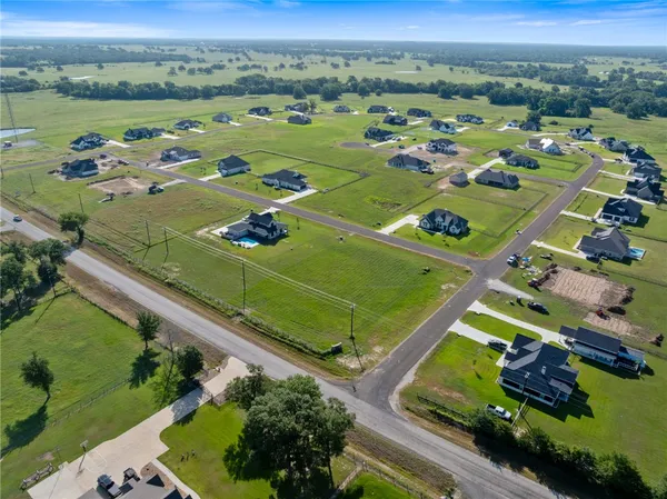 an aerial view of a pool yard and mountain view in back