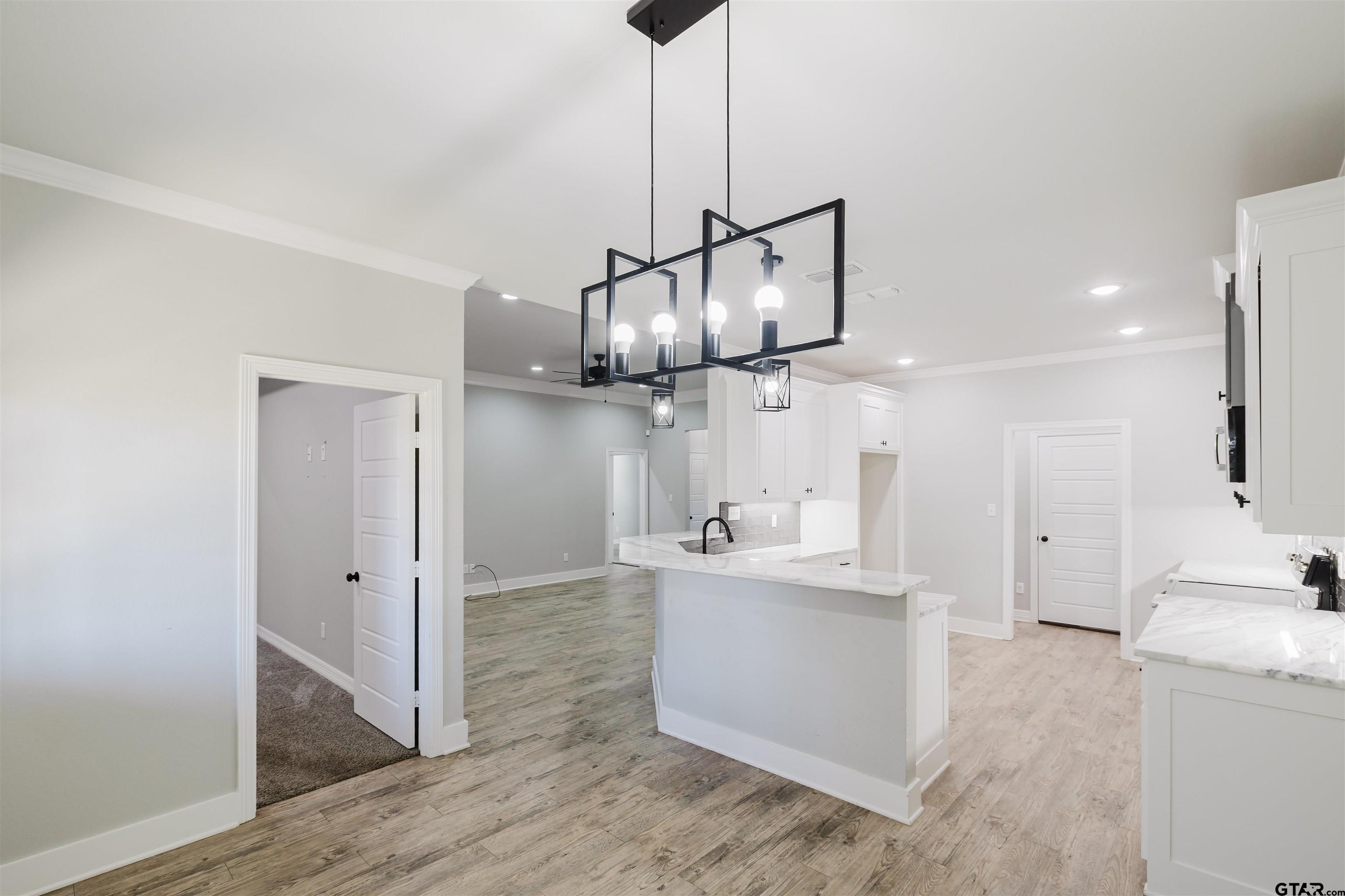 11051 Happy Acres Tyler, TX 75706 - Photo 12 of 36 a kitchen with stainless steel appliances granite countertop a sink a stove a refrigerator and island with wooden floor