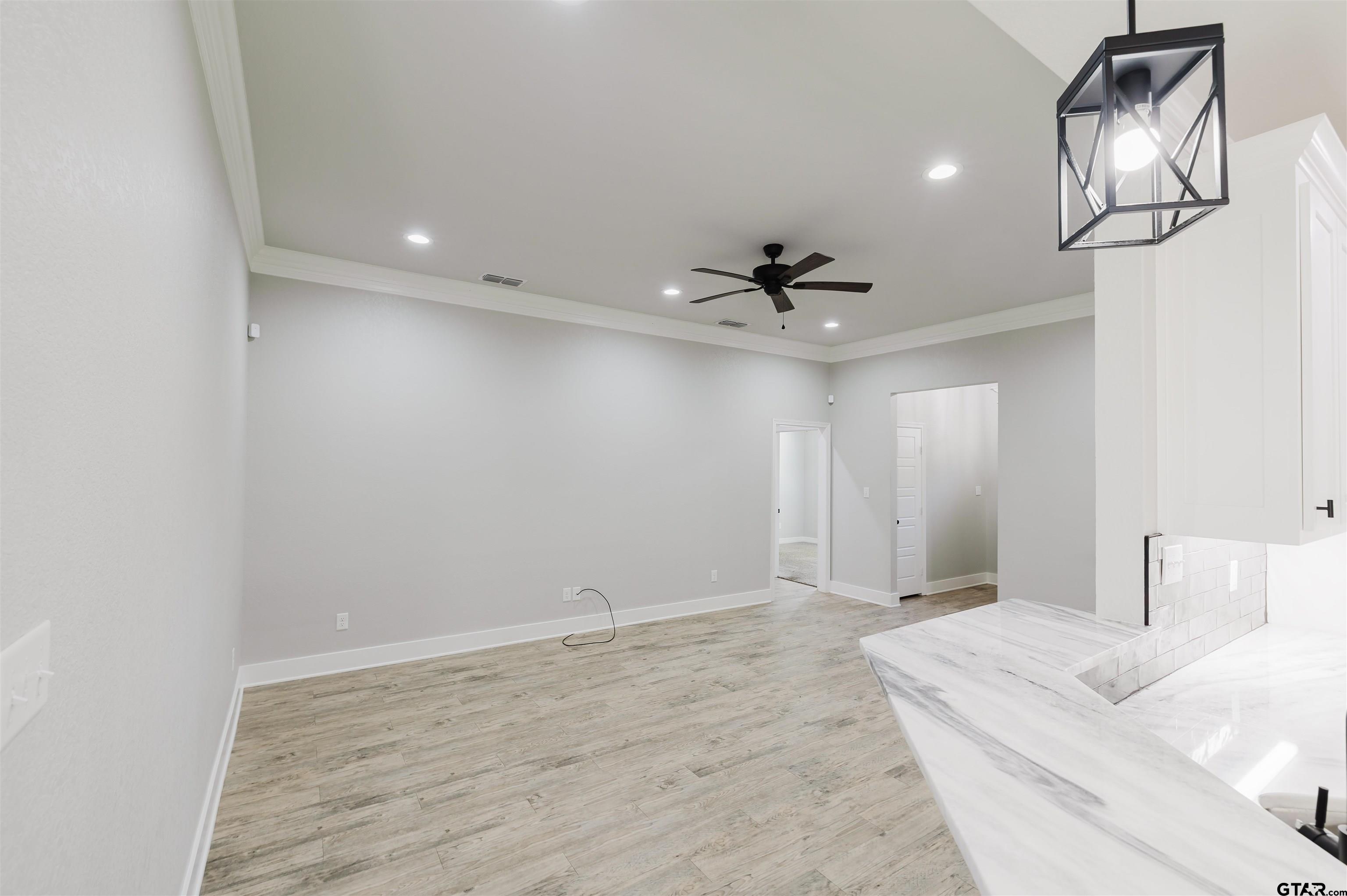 11051 Happy Acres Tyler, TX 75706 - Photo 13 of 36 a view of a livingroom with a chandelier fan and wooden floor