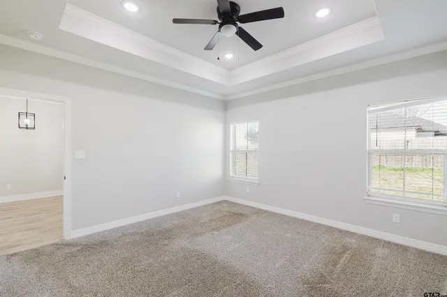 an empty room with a ceiling fan and ceiling fan