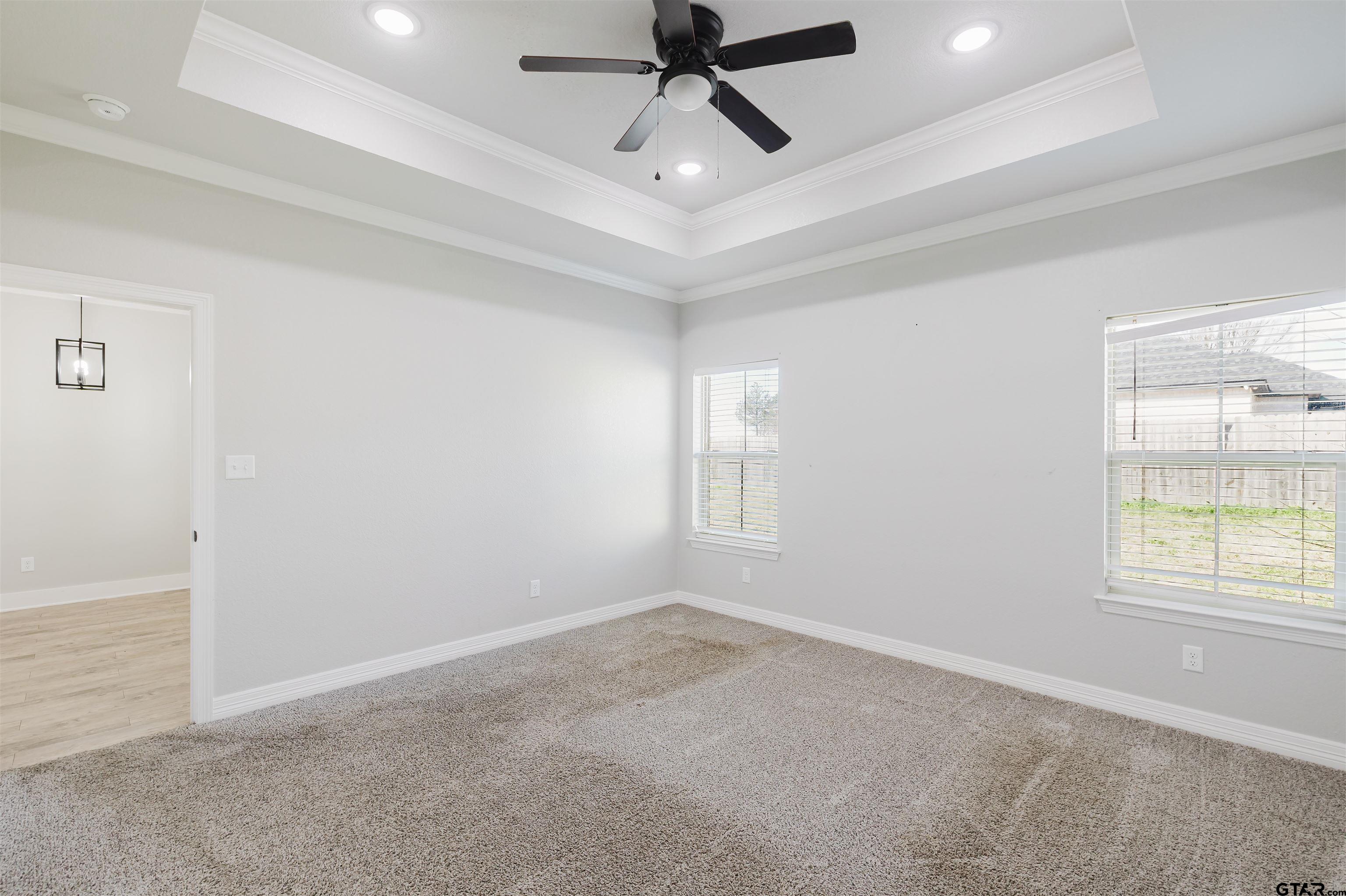 11051 Happy Acres Tyler, TX 75706 - Photo 20 of 36 an empty room with windows and ceiling fan