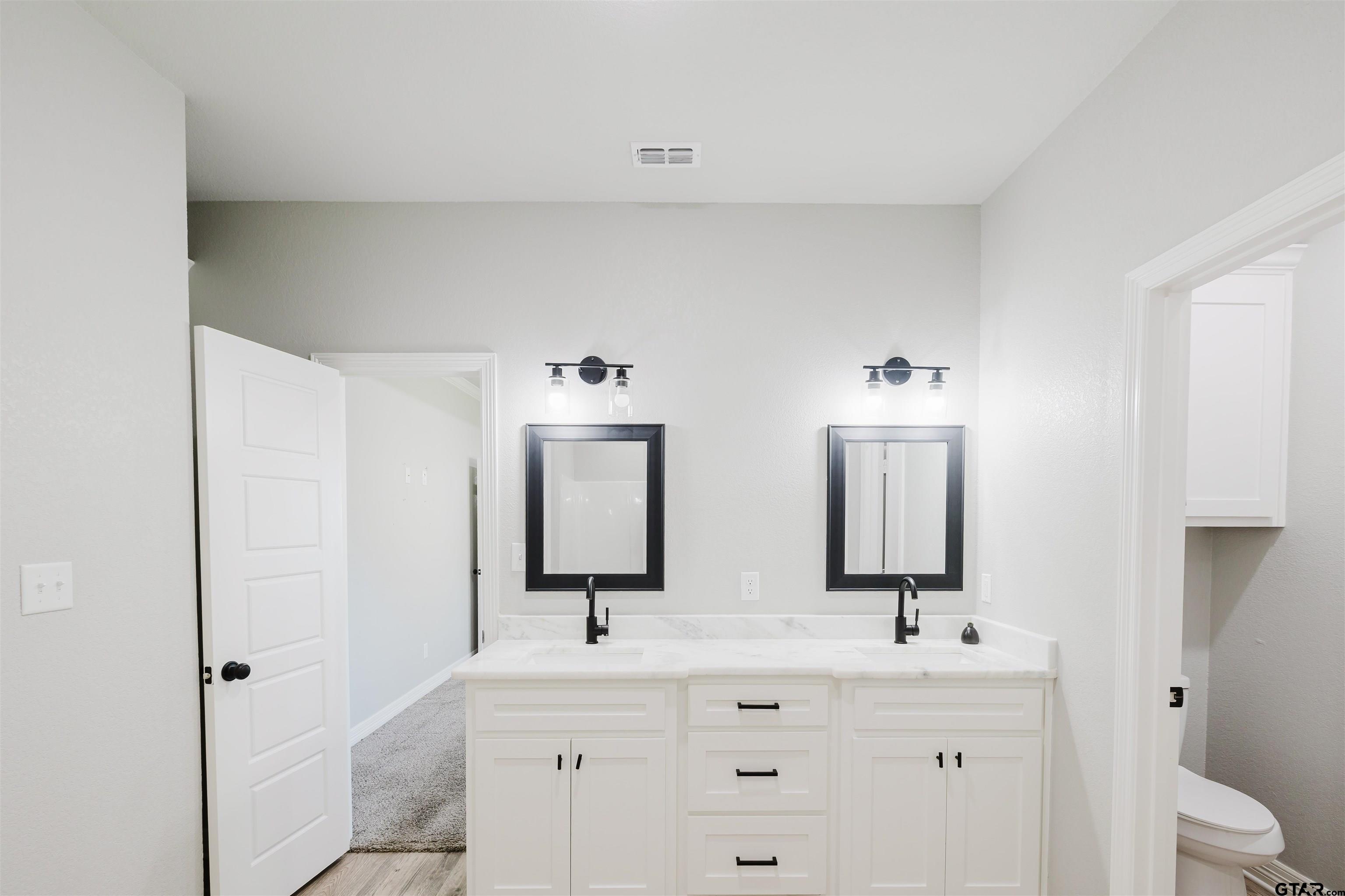 11051 Happy Acres Tyler, TX 75706 - Photo 25 of 36 a bathroom with 2 sink and a mirror