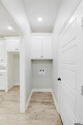 a view of a kitchen with white cabinets