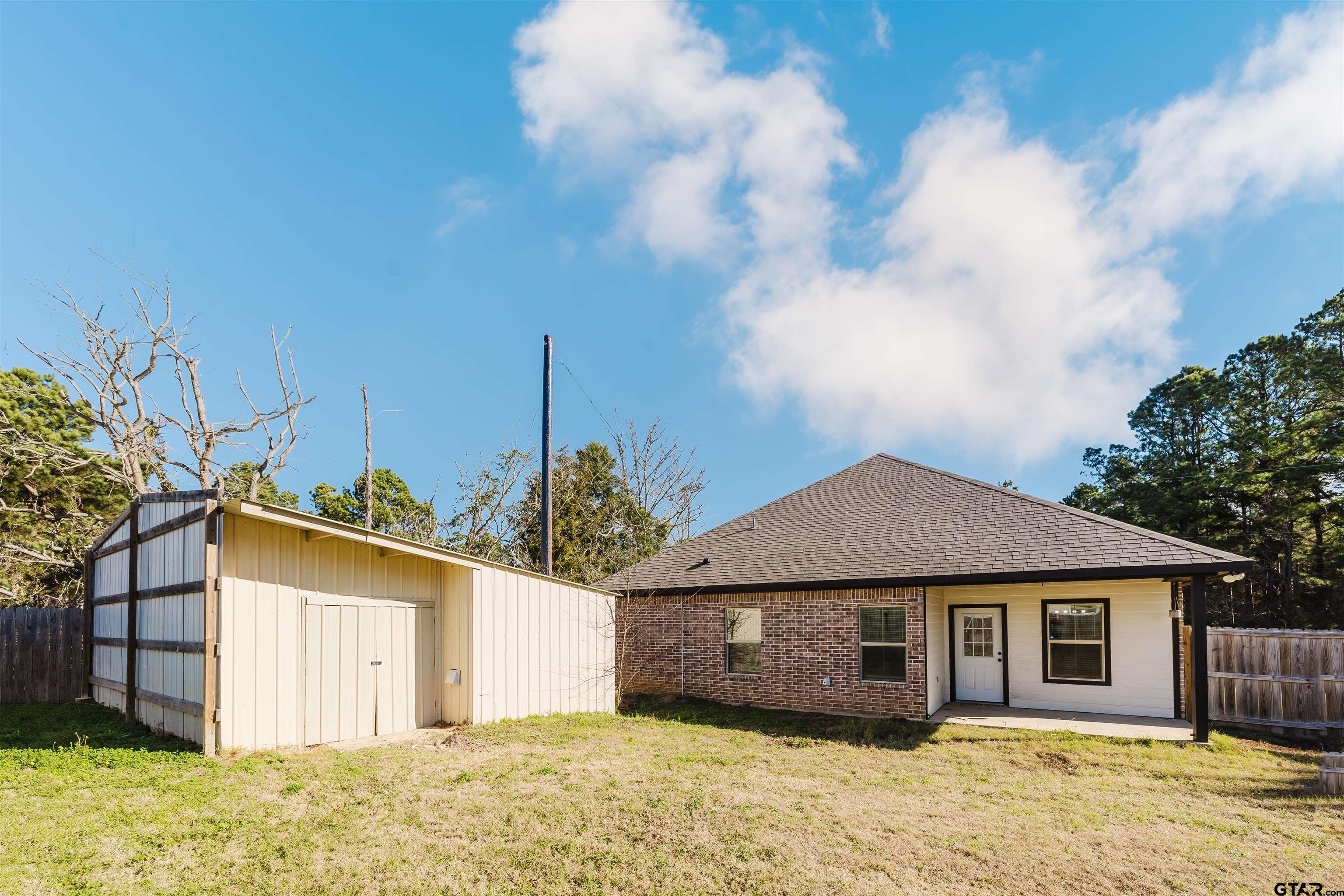11051 Happy Acres Tyler, TX 75706 - Photo 35 of 36 a front view of a house with a yard and garage