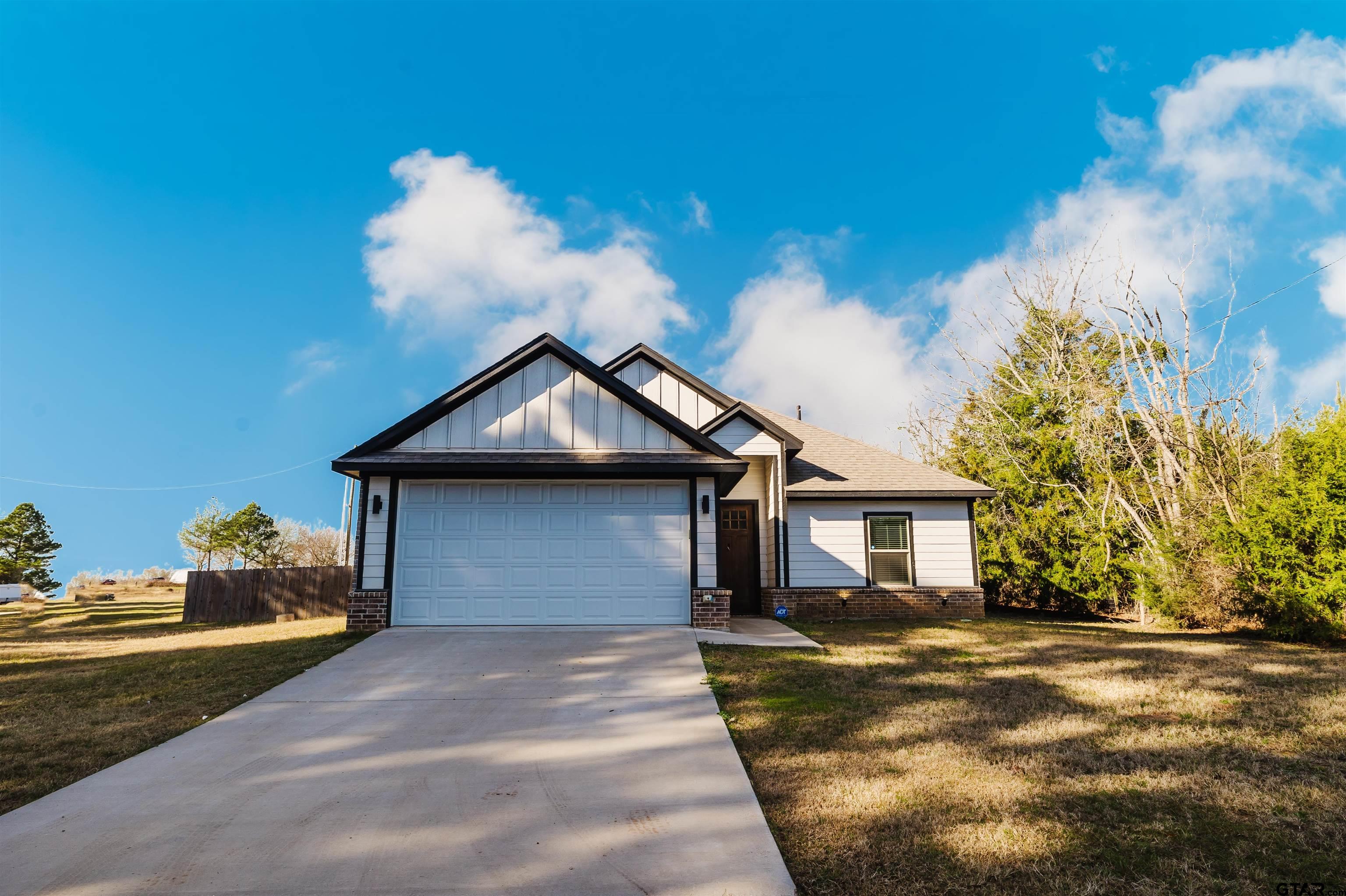 11051 Happy Acres Tyler, TX 75706 - Photo 5 of 36 a front view of a house with a yard and garage