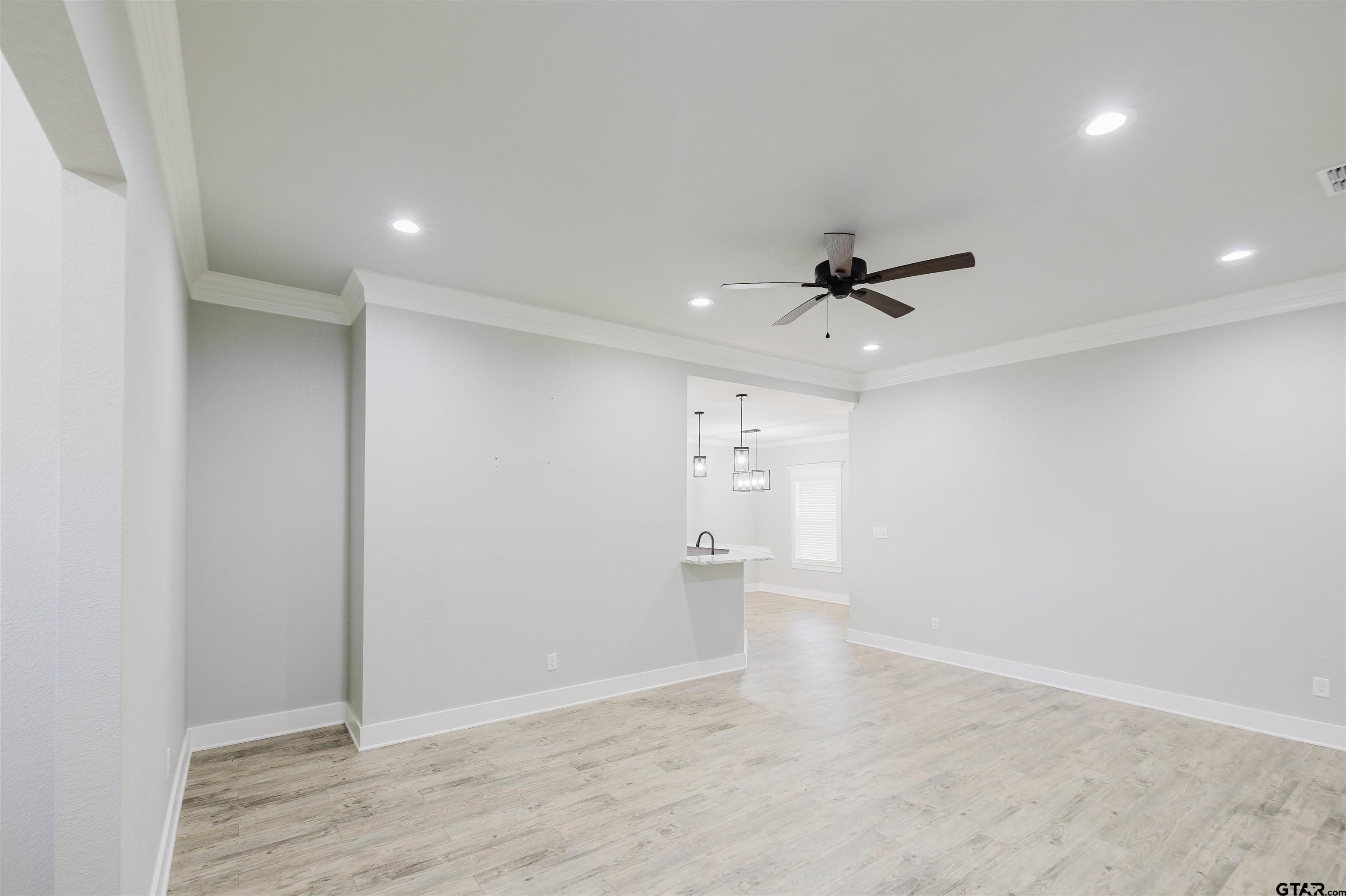 11051 Happy Acres Tyler, TX 75706 - Photo 7 of 36 wooden floor in an empty room with a ceiling fan