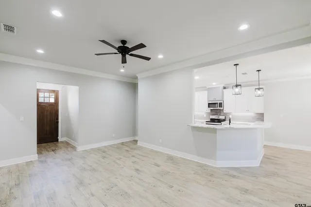 a view of a kitchen with a sink and stainless steel appliances