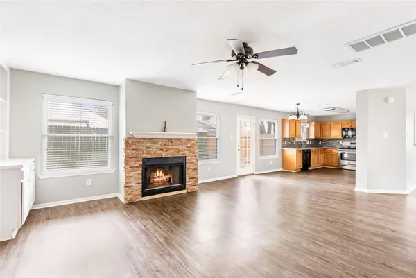 a view of a livingroom with a fireplace and window