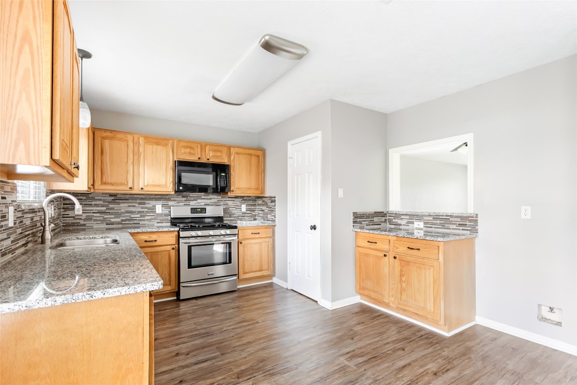 31315 Copperleaf Drive Spring, TX 77386 - Photo 16 of 34 a kitchen with stainless steel appliances granite countertop a stove top oven a sink and a granite counter tops