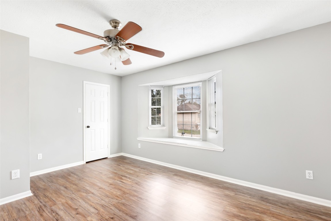 31315 Copperleaf Drive Spring, TX 77386 - Photo 29 of 34 an empty room with wooden floor fan and windows
