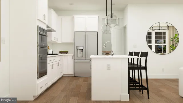 a kitchen with refrigerator cabinets and wooden floor