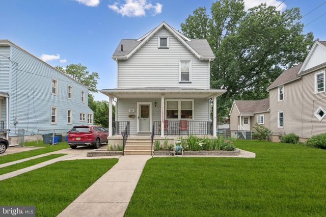 a front view of a house with a garden and plants