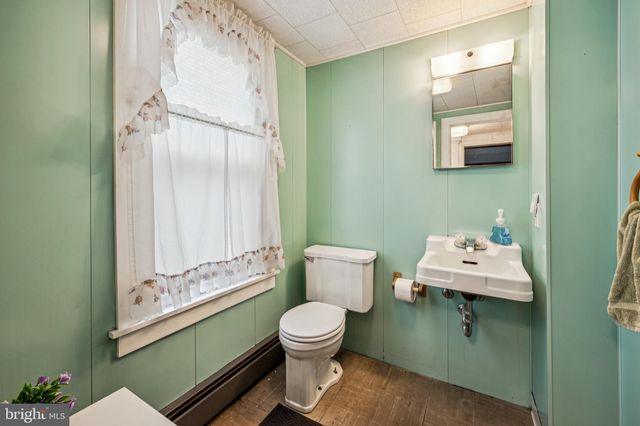 a bathroom with a toilet sink and mirror