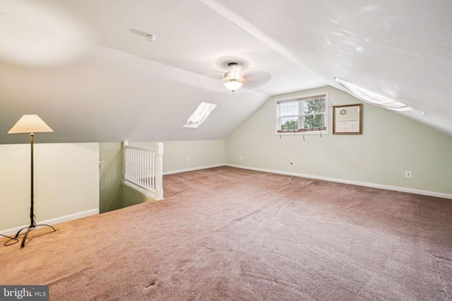 an empty room with fan and windows