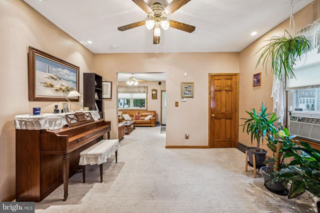 a view of a livingroom with workspace and a window