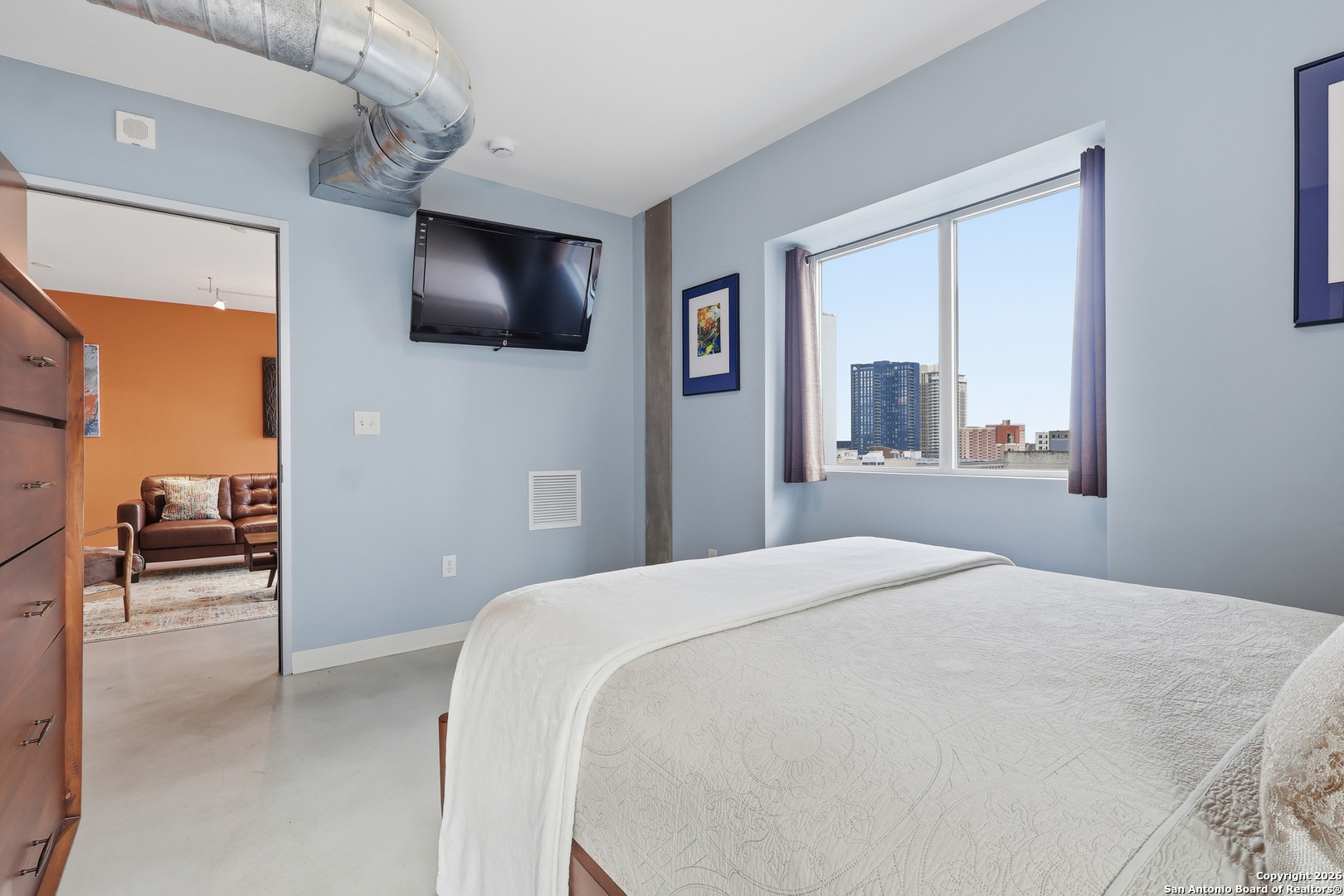 800 Brazos Street, Unit 1103 Austin, TX 78701 - Photo 4 of 26 a bedroom with a bed and a flat tv screen on dresser