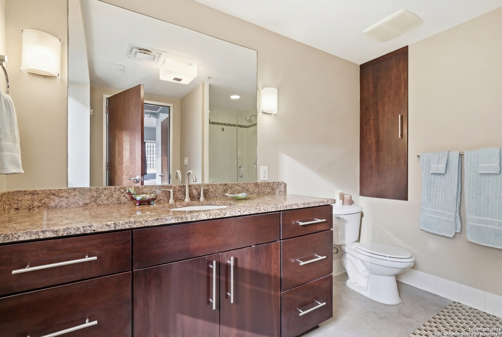 800 Brazos Street, Unit 1103 Austin, TX 78701 - Photo 5 of 26 a bathroom with a granite countertop toilet sink and mirror