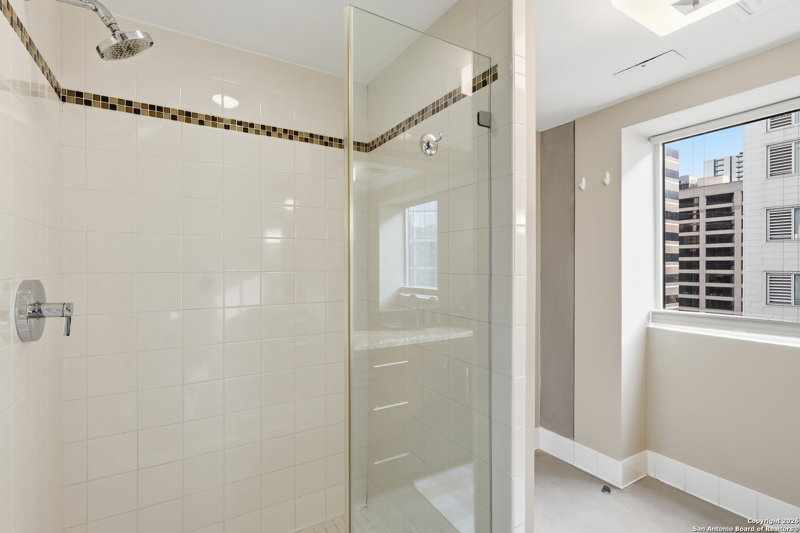 800 Brazos Street, Unit 1103 Austin, TX 78701 - Photo 7 of 26 a bathroom with a glass shower door