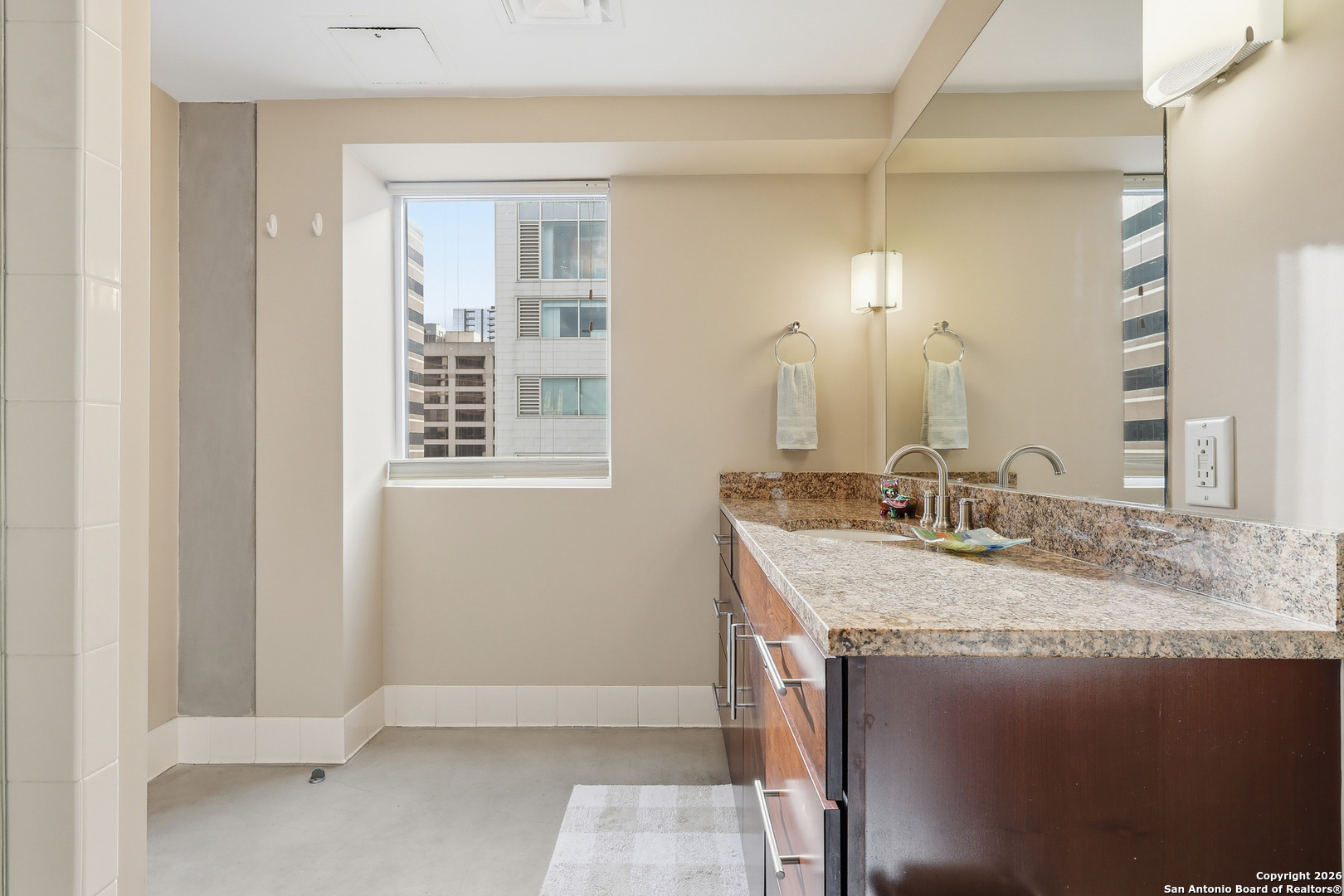 800 Brazos Street, Unit 1103 Austin, TX 78701 - Photo 8 of 26 a bathroom with a granite countertop sink and a mirror