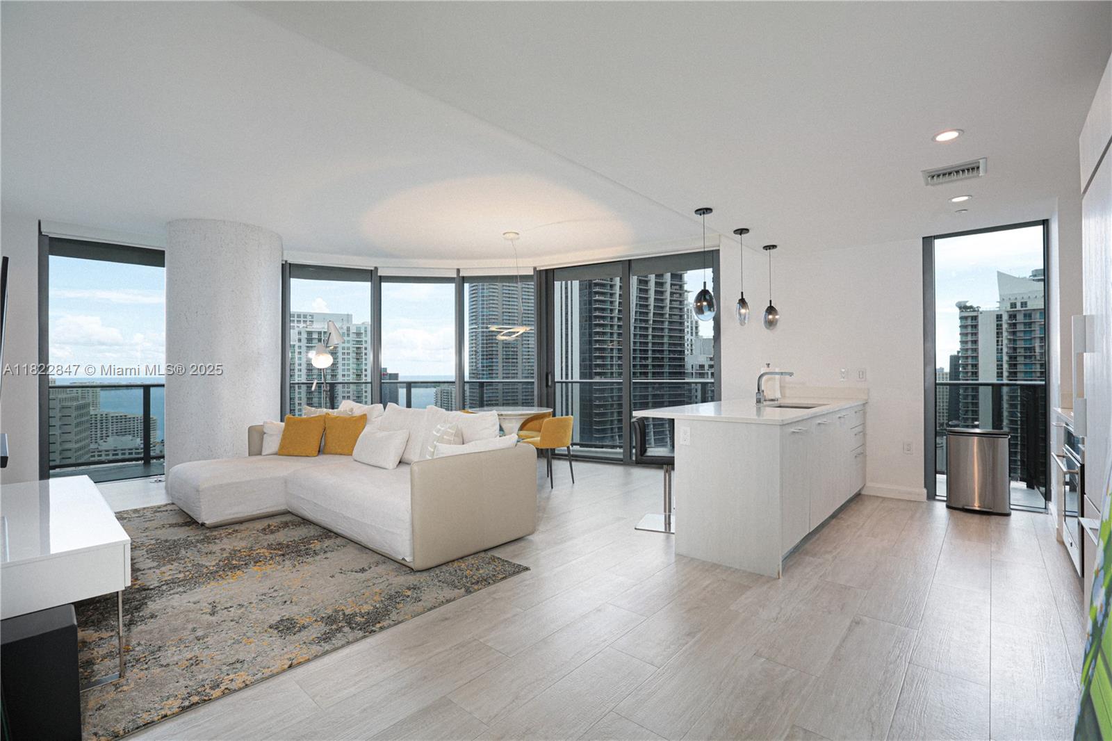 a living room with fireplace furniture and a large window