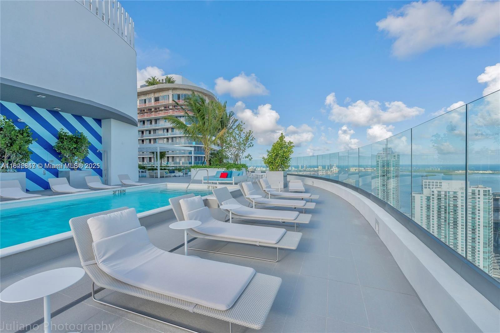45 Southwest 9th Street, Unit 3403 Miami, FL 33130 - Photo 20 of 27 a view of a patio with couches and table and chairs and potted plants