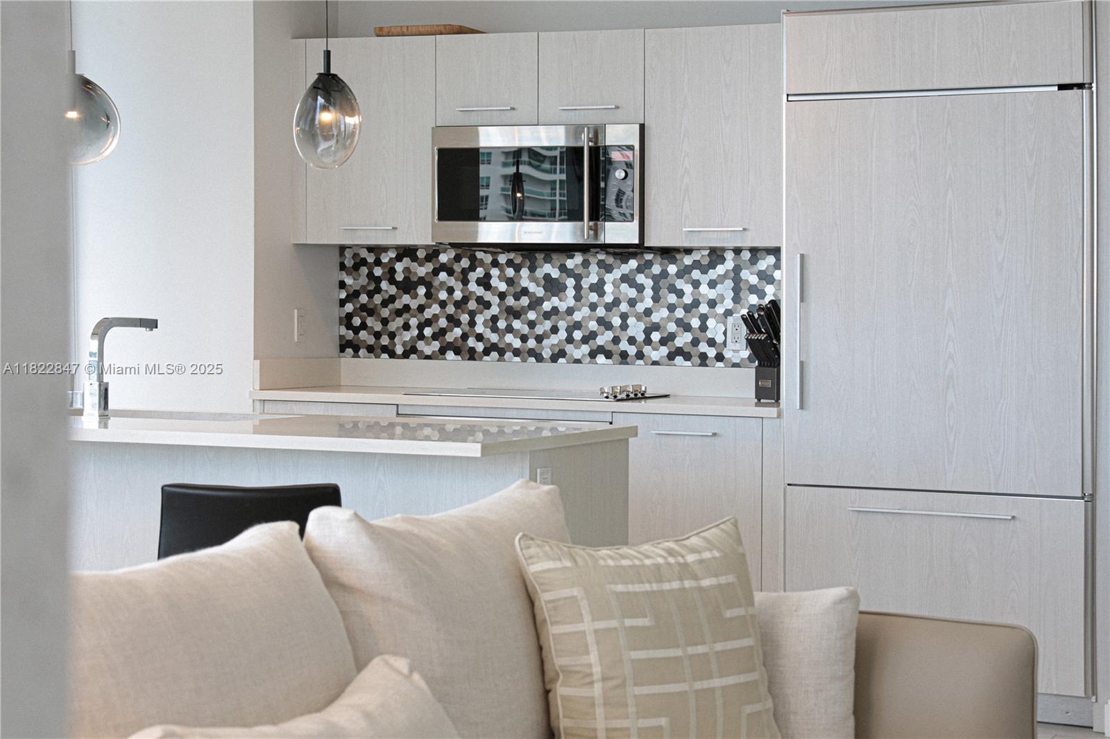 45 Southwest 9th Street, Unit 3403 Miami, FL 33130 - Photo 3 of 27 a kitchen with a sink and a refrigerator