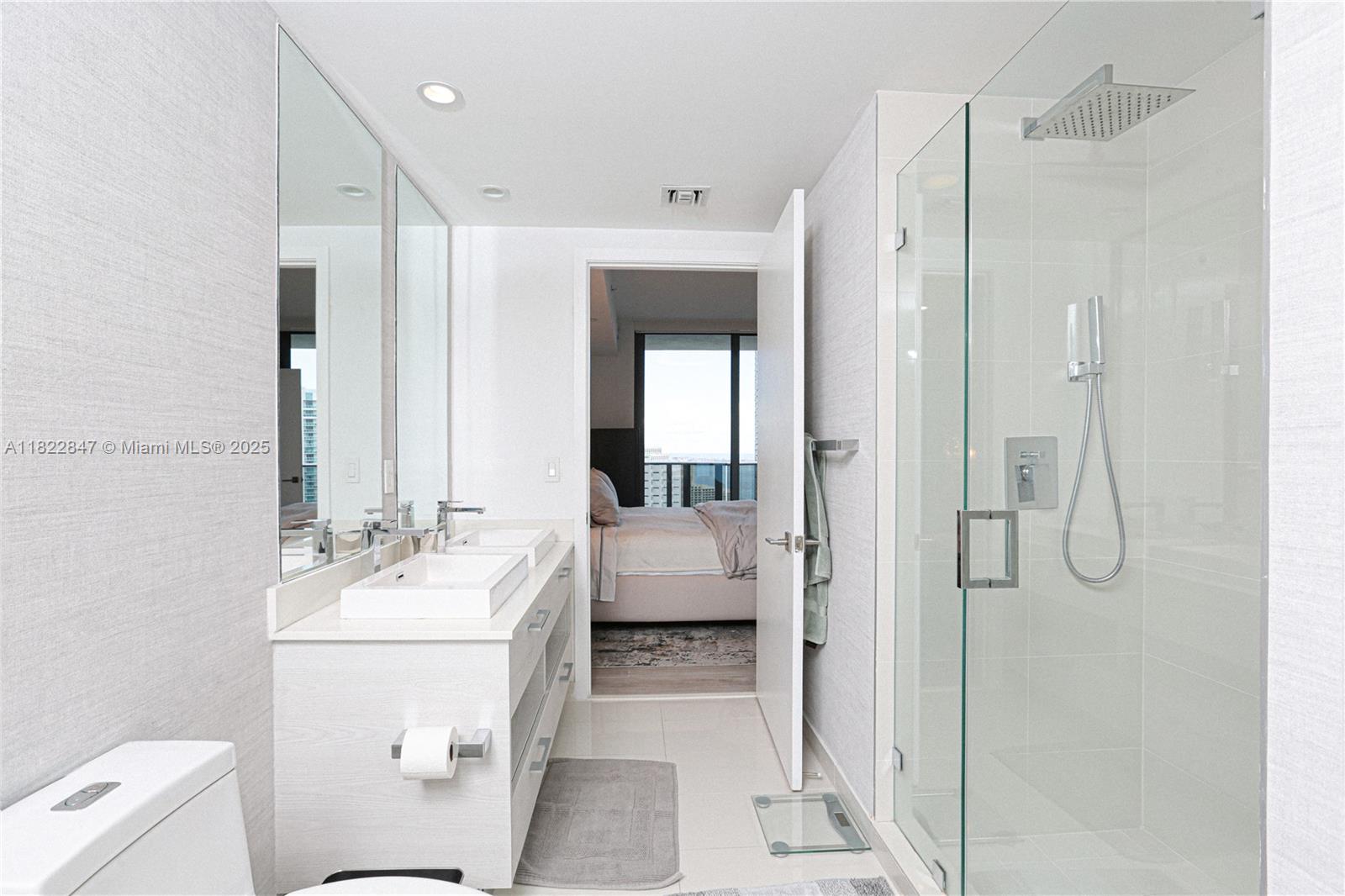 45 Southwest 9th Street, Unit 3403 Miami, FL 33130 - Photo 6 of 27 a bathroom with a double vanity sink mirror and toilet