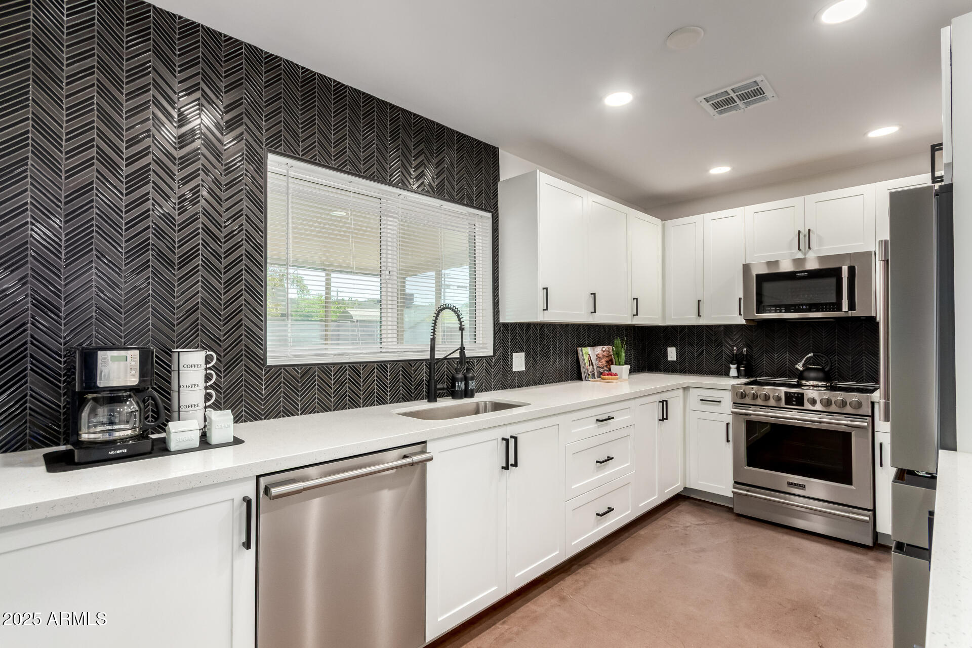 4735 North 24th Street Phoenix, AZ 85016 - Photo 12 of 44 a kitchen with granite countertop a sink stainless steel appliances and white cabinets