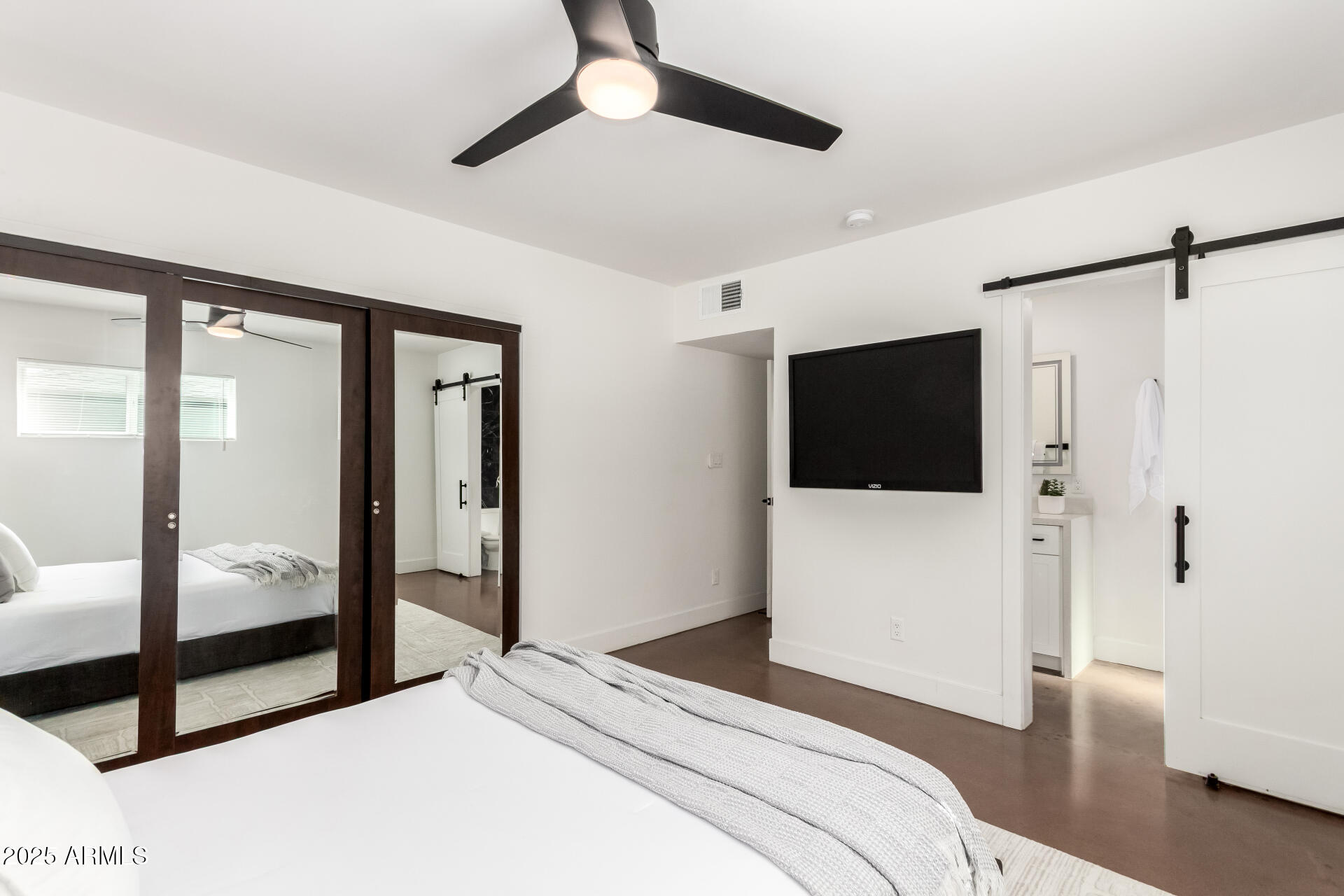 4735 North 24th Street Phoenix, AZ 85016 - Photo 15 of 44 a bedroom with a large bed and a glass door