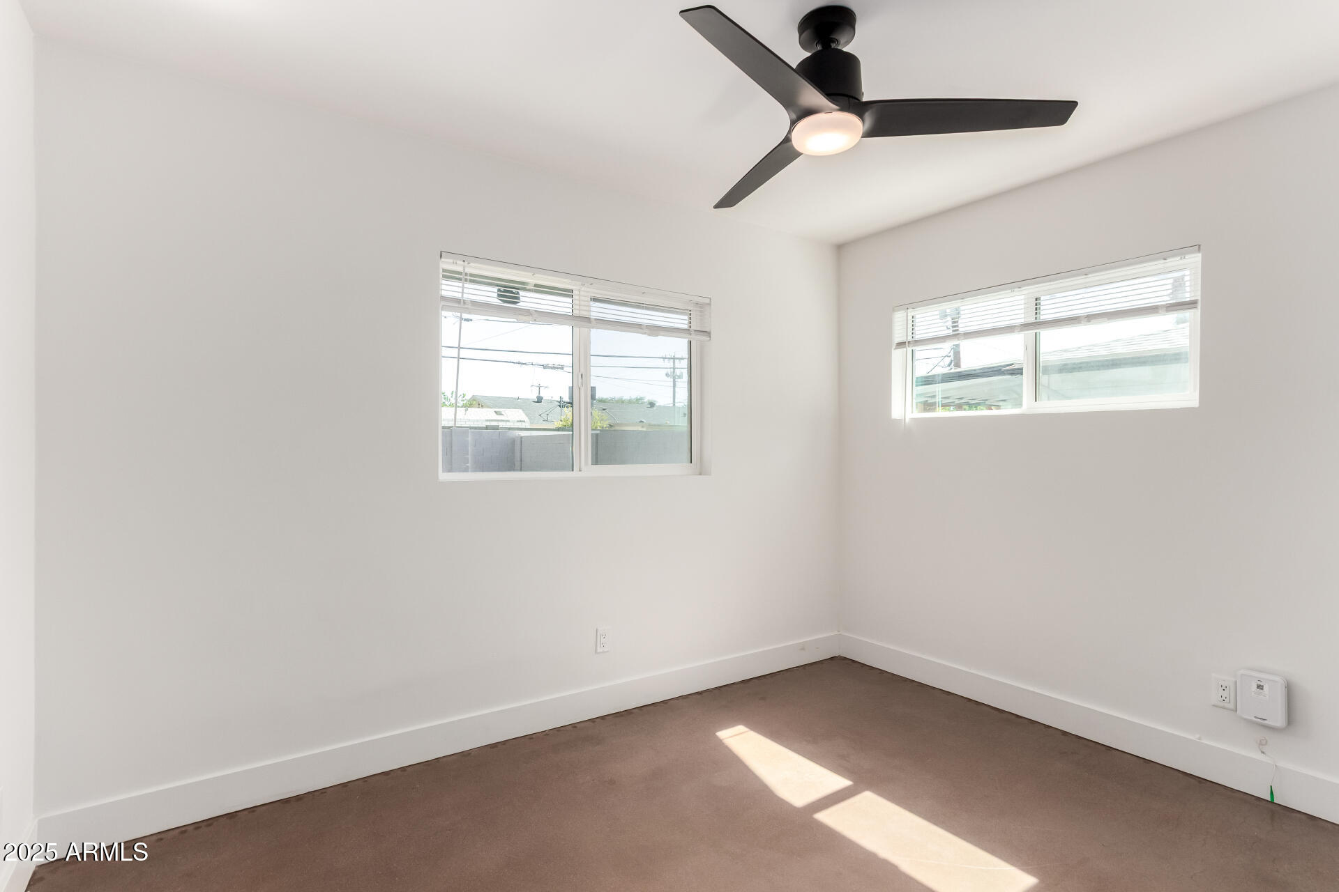 4735 North 24th Street Phoenix, AZ 85016 - Photo 19 of 44 an empty room with a window and a fan