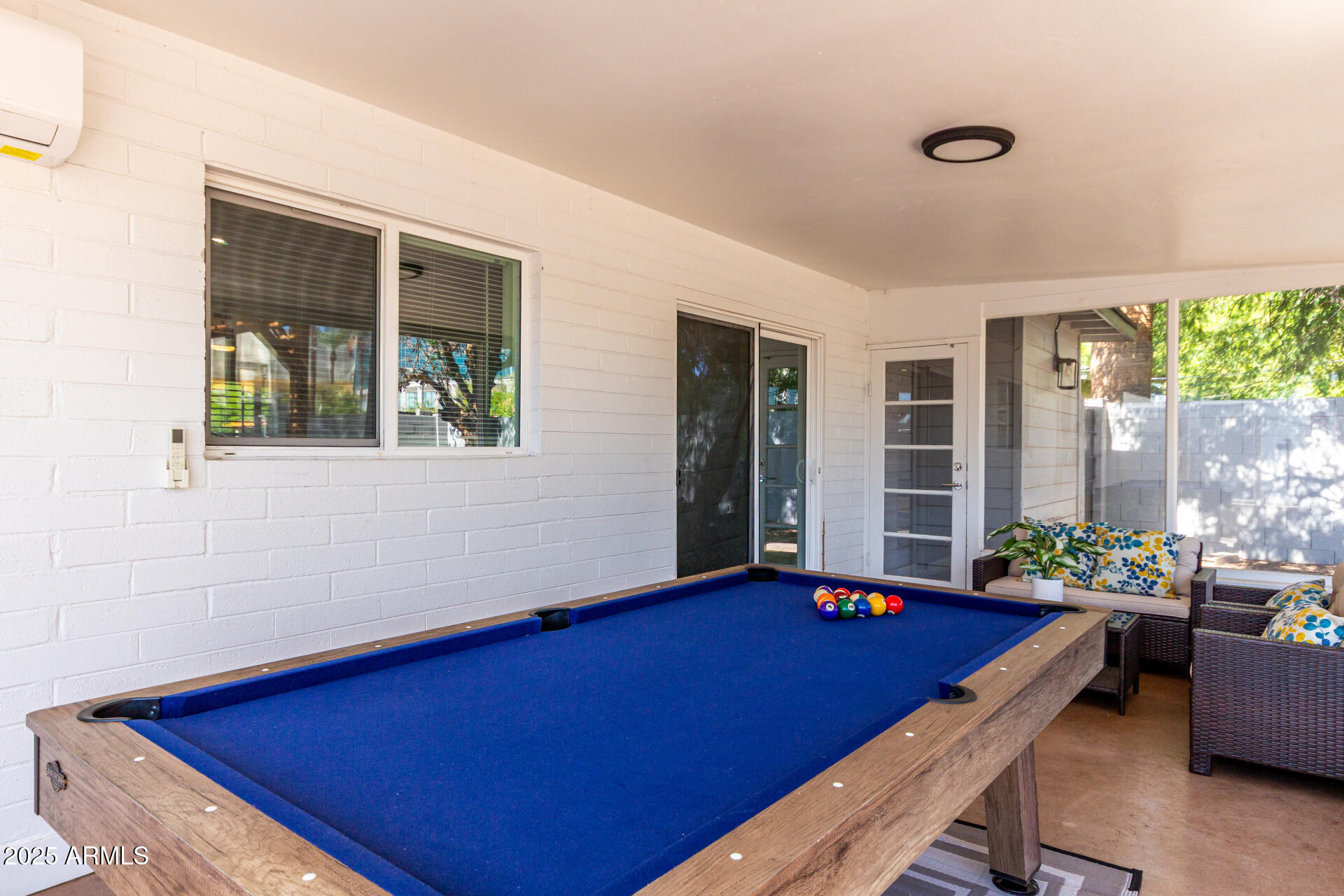 4735 North 24th Street Phoenix, AZ 85016 - Photo 26 of 44 a living room with furniture pool table and a large window