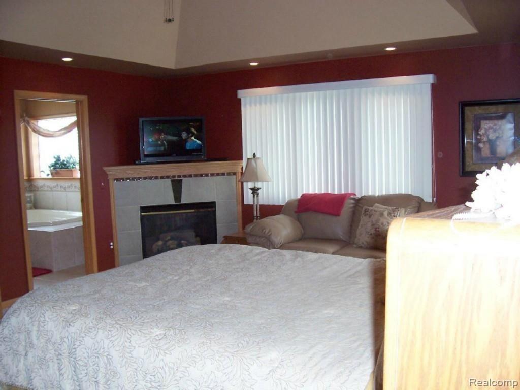 14470 Hough Road Allenton, MI 48002 - Photo 17 of 39 master bedroom with gas fireplace and private bath