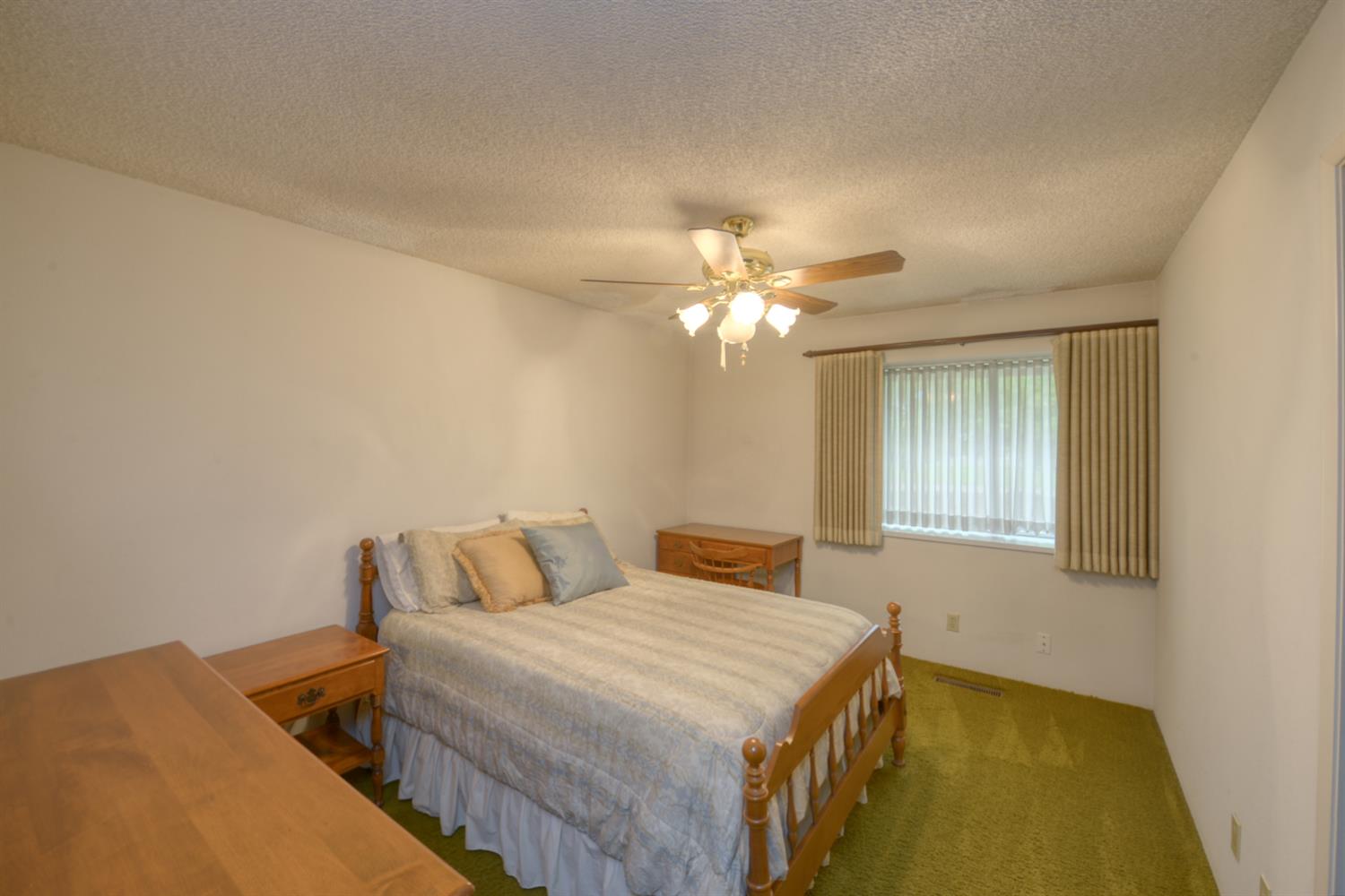 1471 Highway 33 Gustine, CA 95322 - Photo 23 of 57 a spacious bedroom with a bed and a chandelier