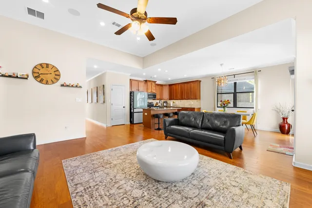 a living room with furniture and a wooden floor