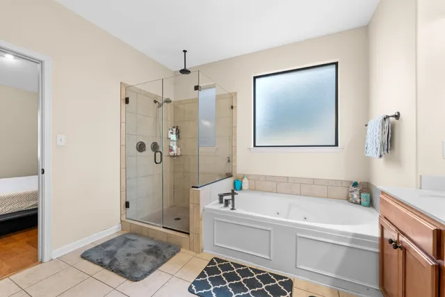 a bathroom with a bathtub and a shower