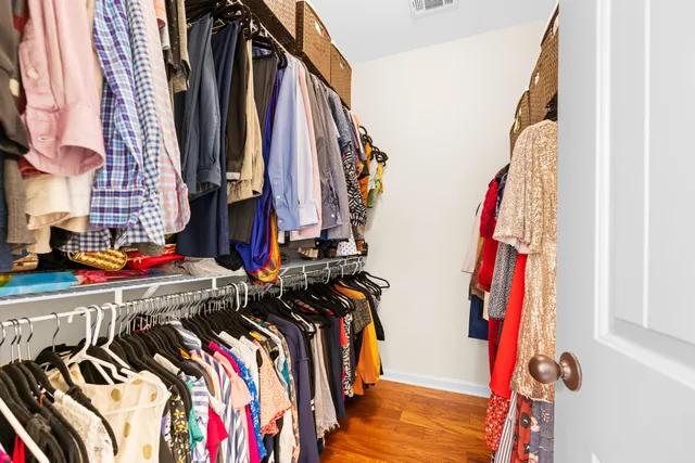 a view of walk in closet with clothes