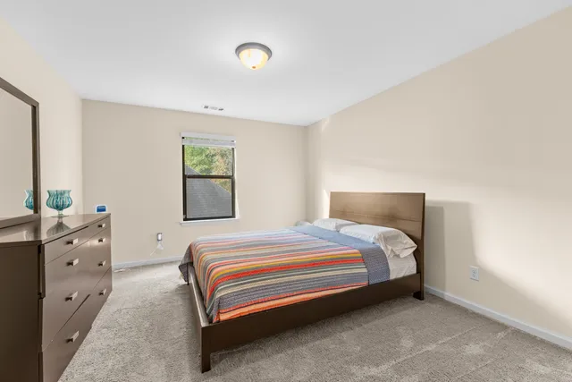 a bedroom with a bed and a dresser