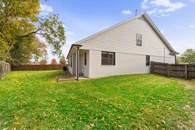 a view of backyard of house with green space