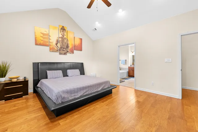 a spacious bedroom with a bed and a chandelier