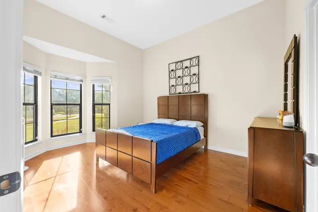 a bedroom with a bed and glass door