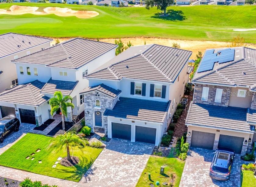 a aerial view of a house with a garden and swimming pool