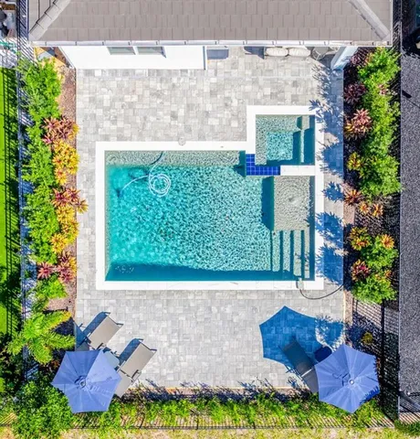 a view of swimming pool with outdoor seating and plants