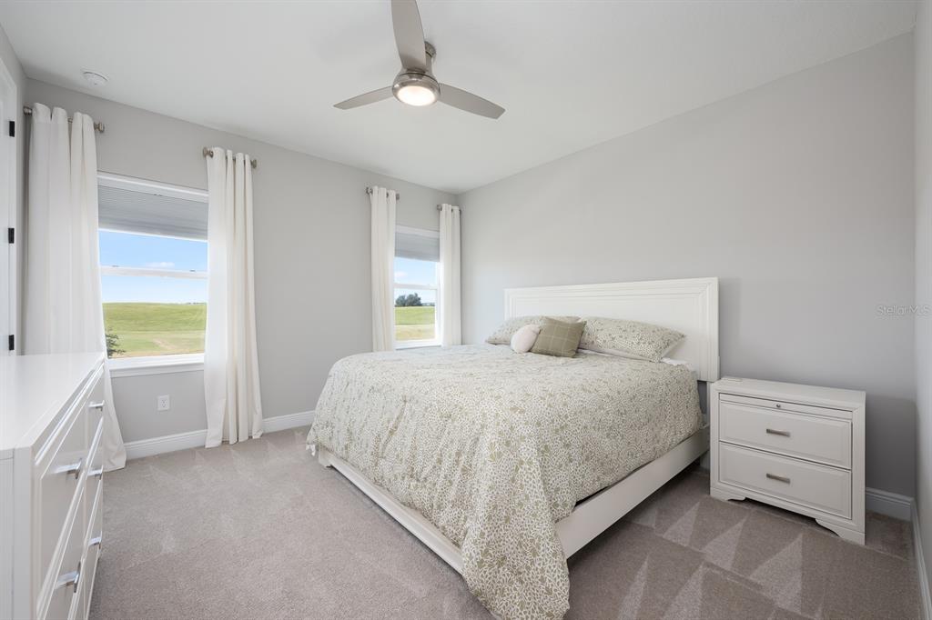 15714 Vetta Drive Montverde, FL 34756 - Photo 23 of 45 a bedroom with a bed and a dresser