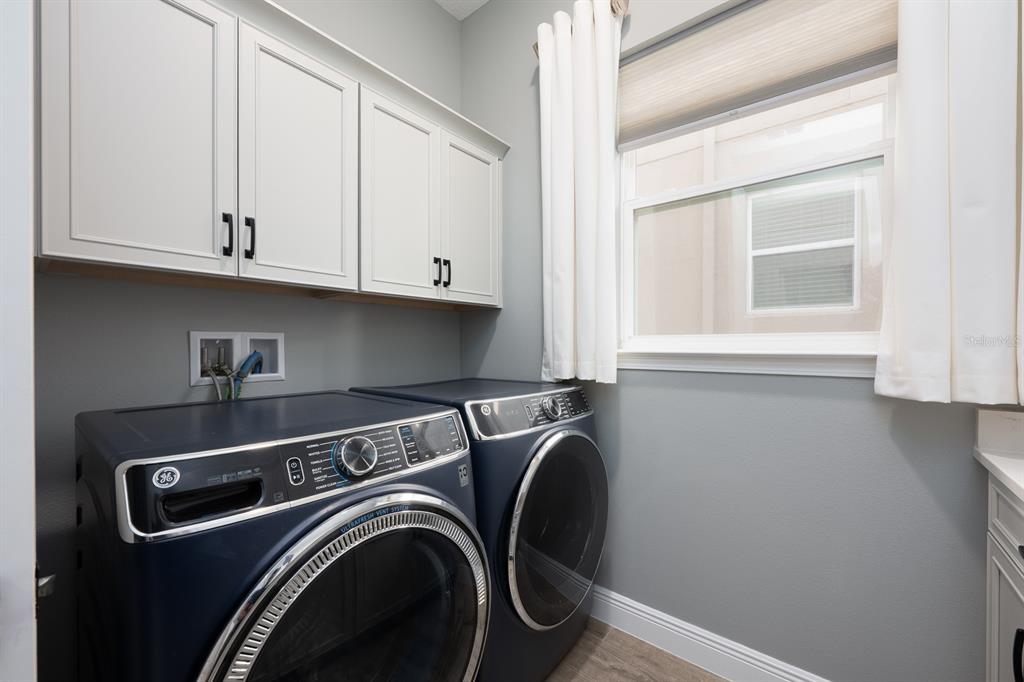15714 Vetta Drive Montverde, FL 34756 - Photo 27 of 45 a view of storage and utility room with washer and dryer